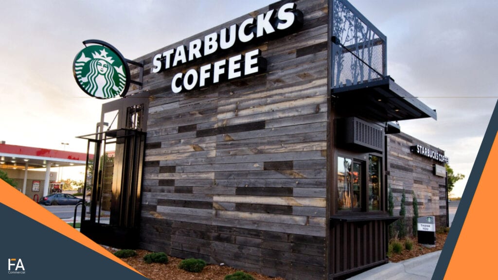 A Strabucks bilding made out of wood and a recycled container